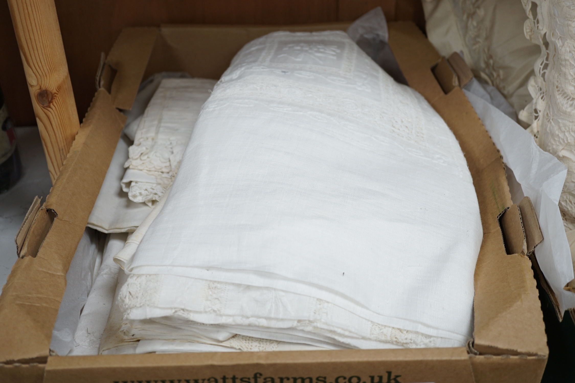 A collection of embroidered and crochet edged table linen, three silk boudoir cushions and a pin cushion. Condition - the linen needs re-laundering and silk cushions have some staining